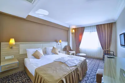 a hotel room with a bed and a window at Hotel Grand Emin in Istanbul