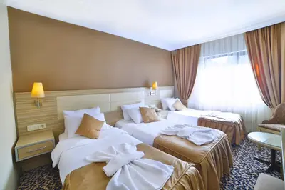 a hotel room with two beds with towels on them at Hotel Grand Emin in Istanbul