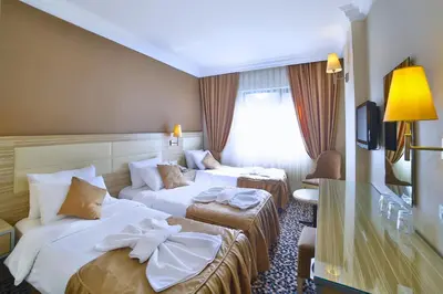 a hotel room with two beds with towels on them at Hotel Grand Emin in Istanbul