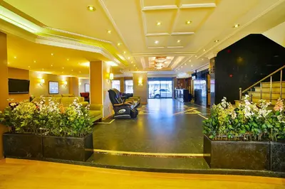an office lobby with plants in the middle of it at Hotel Grand Emin in Istanbul