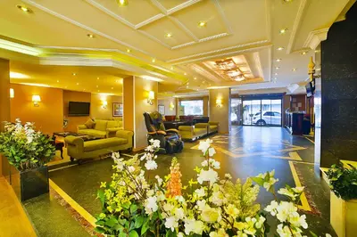 a lobby with couches and flowers in a building at Hotel Grand Emin in Istanbul