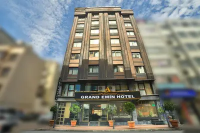 a tall building with a sign in front of it at Hotel Grand Emin in Istanbul