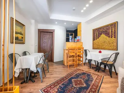a dining room with tables and chairs and a rug at Magnificent Hotel in Istanbul