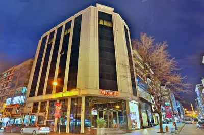 a tall building on a city street at night at Grand Madrid Hotel in Istanbul