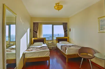 a hotel room with two beds and a table at Grand Madrid Hotel in Istanbul