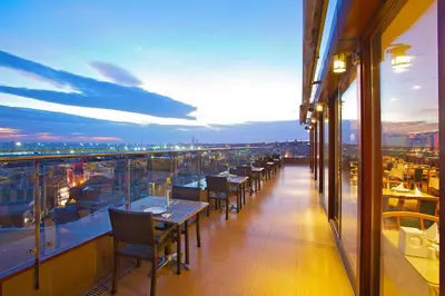 a balcony of a restaurant with tables and chairs at Grand Madrid Hotel in Istanbul