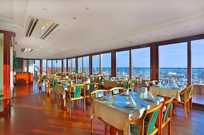 a dining room with tables and chairs and windows at Grand Madrid Hotel in Istanbul