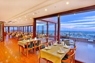 a restaurant with tables and chairs with a view at Grand Madrid Hotel in Istanbul