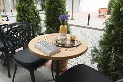 a table with a book and a vase of flowers on it at Cumbali Luxury Boutique Hotel in Istanbul