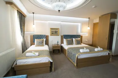 a hotel room with two beds with towels on them at Cumbali Luxury Boutique Hotel in Istanbul