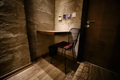 a room with a chair and a table in a room at Elibol Hotel Old City in Istanbul