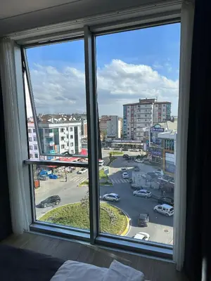a bedroom window with a view of a parking lot at Skyport Istanbul in Istanbul