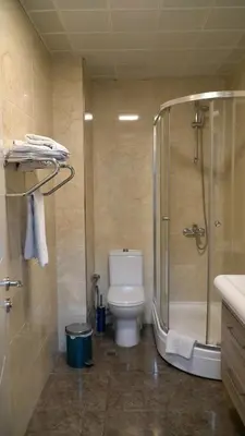 a bathroom with a shower and a toilet and a sink at Skyport Istanbul in Istanbul