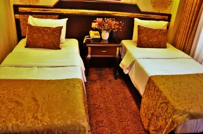 a hotel room with two beds and a table with flowers at Sultanahmet Park Hotel in Istanbul