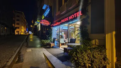 an empty street at night with a sign for a store at Sultanahmet Park Hotel in Istanbul
