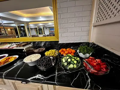 a kitchen counter with bowls of fruits and vegetables on it at Seher HOTEL in Istanbul
