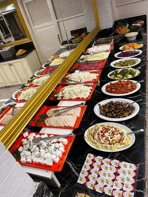 a long line of plates of food on a table at Seher HOTEL in Istanbul
