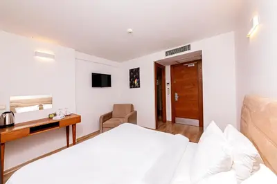 a bedroom with a bed and a desk and a chair at Neda in Istanbul