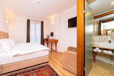a bedroom with a bed and a bathroom with a sink at Neda in Istanbul