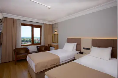 a hotel room with two beds and a window at Grand Ant Hotel in Istanbul