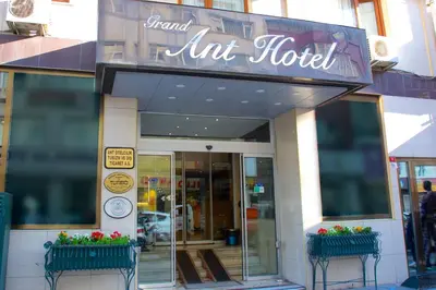 a store front of a art hotel with two flower pots at Grand Ant Hotel in Istanbul
