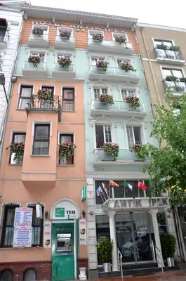 a tall building with windows and flower boxes on it at Antik Ipek Hotel in Istanbul