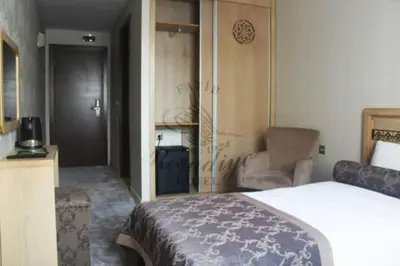 a bedroom with a bed and a chair in a room at Fatih Resadiye Hotel in Istanbul