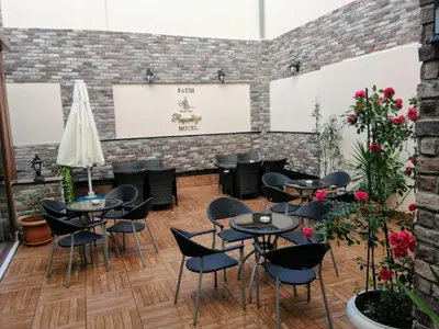 a restaurant with tables and chairs and a brick wall at Fatih Resadiye Hotel in Istanbul