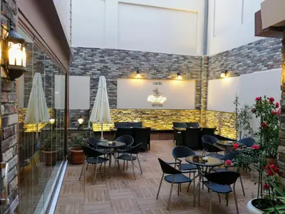 a restaurant with tables and chairs and a brick wall at Fatih Resadiye Hotel in Istanbul
