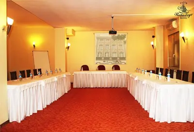 a large room with rows of tables and chairs at Fatih Resadiye Hotel in Istanbul