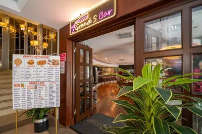 a restaurant entrance with a sign in front of it at Grand S Hotel in Istanbul