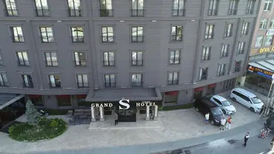a large building with cars parked in front of it at Grand S Hotel in Istanbul