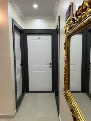 a hallway with a white door and a mirror at Nova Roma Hotel in Istanbul