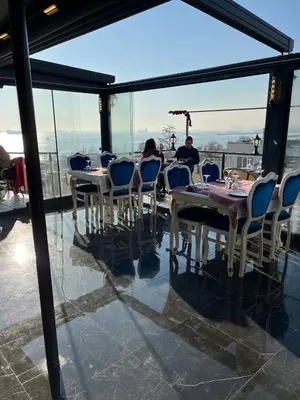 a restaurant with tables and chairs and a view of the city at Nova Roma Hotel in Istanbul
