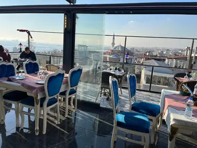 a restaurant with tables and chairs and a view of the city at Nova Roma Hotel in Istanbul