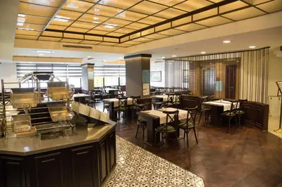 a restaurant with tables and chairs in a room at Dila Hotel in Istanbul