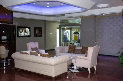 a lobby with a couch and chairs and a blue light at Hermanos Hotel in Istanbul