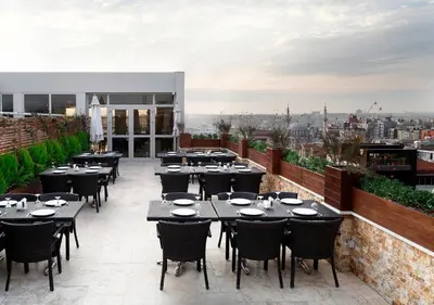 a restaurant with tables and chairs on a roof at Darkhill Hotel in Istanbul