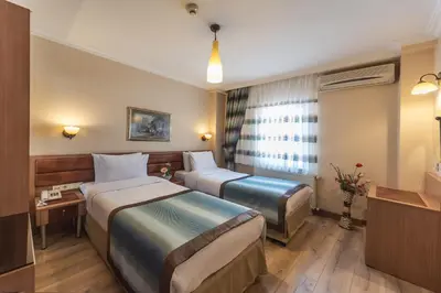 a hotel room with two beds and a television at Senabil Hotel Old City & Spa in Istanbul