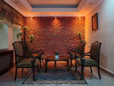 a room with chairs and a table and a brick wall at Sirkeci Emek Hotel in Istanbul