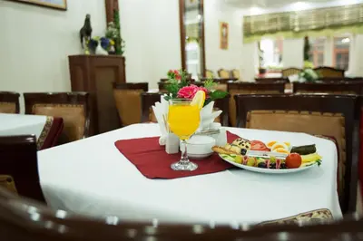 a table with a plate of food and a glass of juice at Sirkeci Emek Hotel in Istanbul