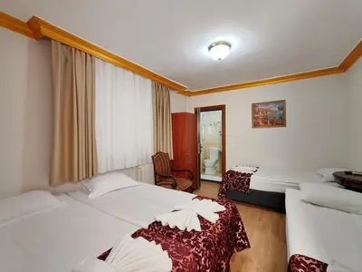 a hotel room with two beds and a window at Sirkeci Emek Hotel in Istanbul