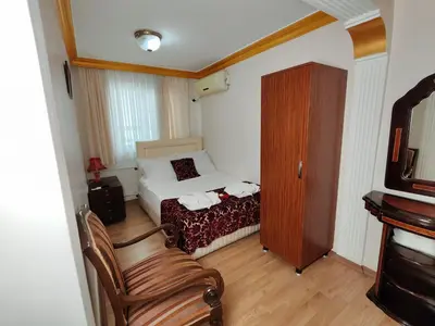 a small bedroom with a bed and a chair at Sirkeci Emek Hotel in Istanbul