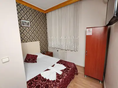 a small room with a bed and a window at Sirkeci Emek Hotel in Istanbul