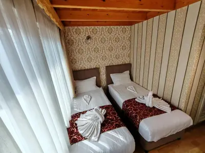 two beds in a room with white sheets at Sirkeci Emek Hotel in Istanbul
