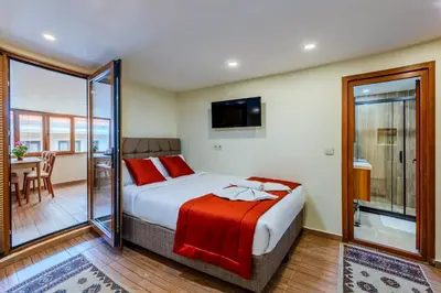 a bedroom with a large bed and a balcony at Hotel Silviya in Istanbul