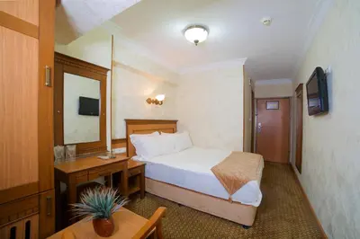 a hotel room with a bed and a table at Grand Unal Hotel in Istanbul