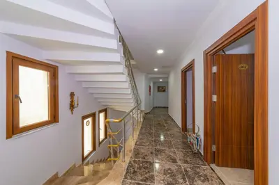 a staircase in a home with white walls and wooden doors at Rosalie Palace Hotel in Istanbul