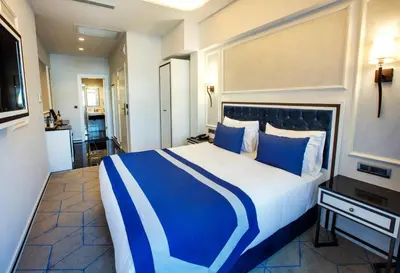 a blue and white bed in a hotel room at Endican Beyazit Hotel in Istanbul