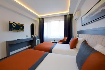 a hotel room with two beds and a window at Hotel Eyfel in Istanbul